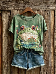 Damen-T-Shirt mit kunstvoller Druckmotiv-Optik: niedlicher Frosch und Teichszene, kurzärmelig